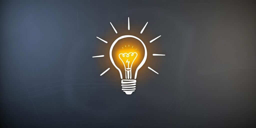 黒板に描かれた明るい電球のスケッチ